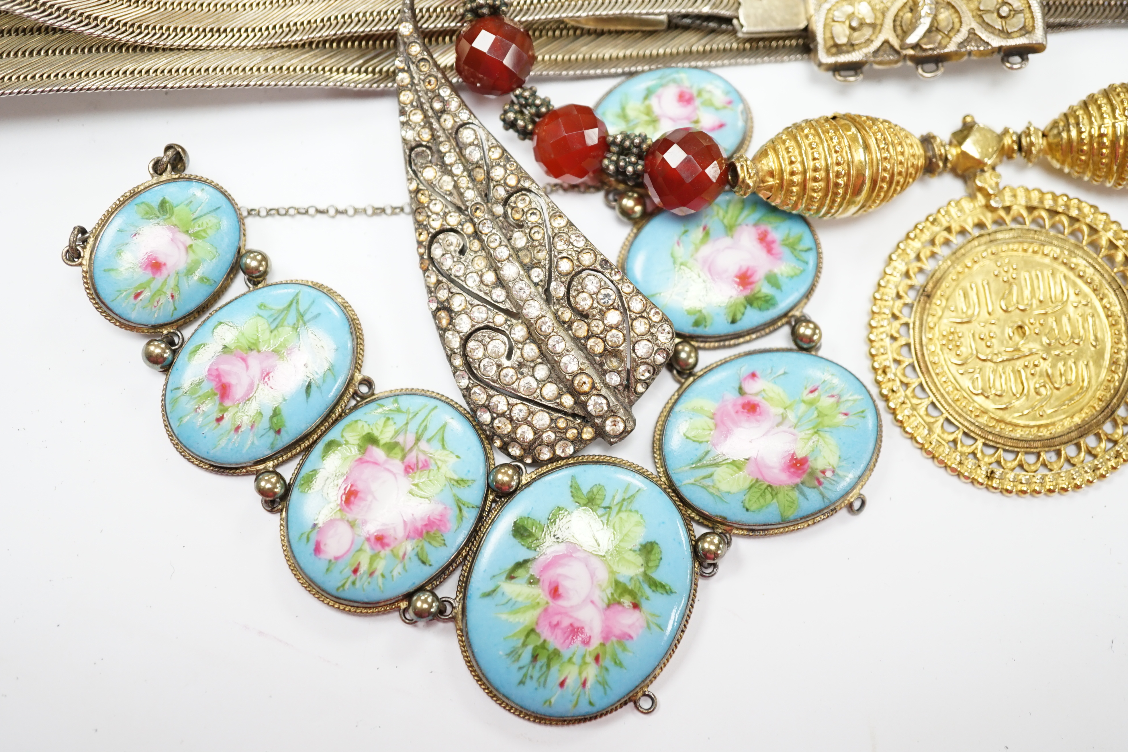 A group of assorted jewellery, including a Persian gilt white metal belt and a French gilt white metal and graduated porcelain plaque set bracelet. Fair condition.